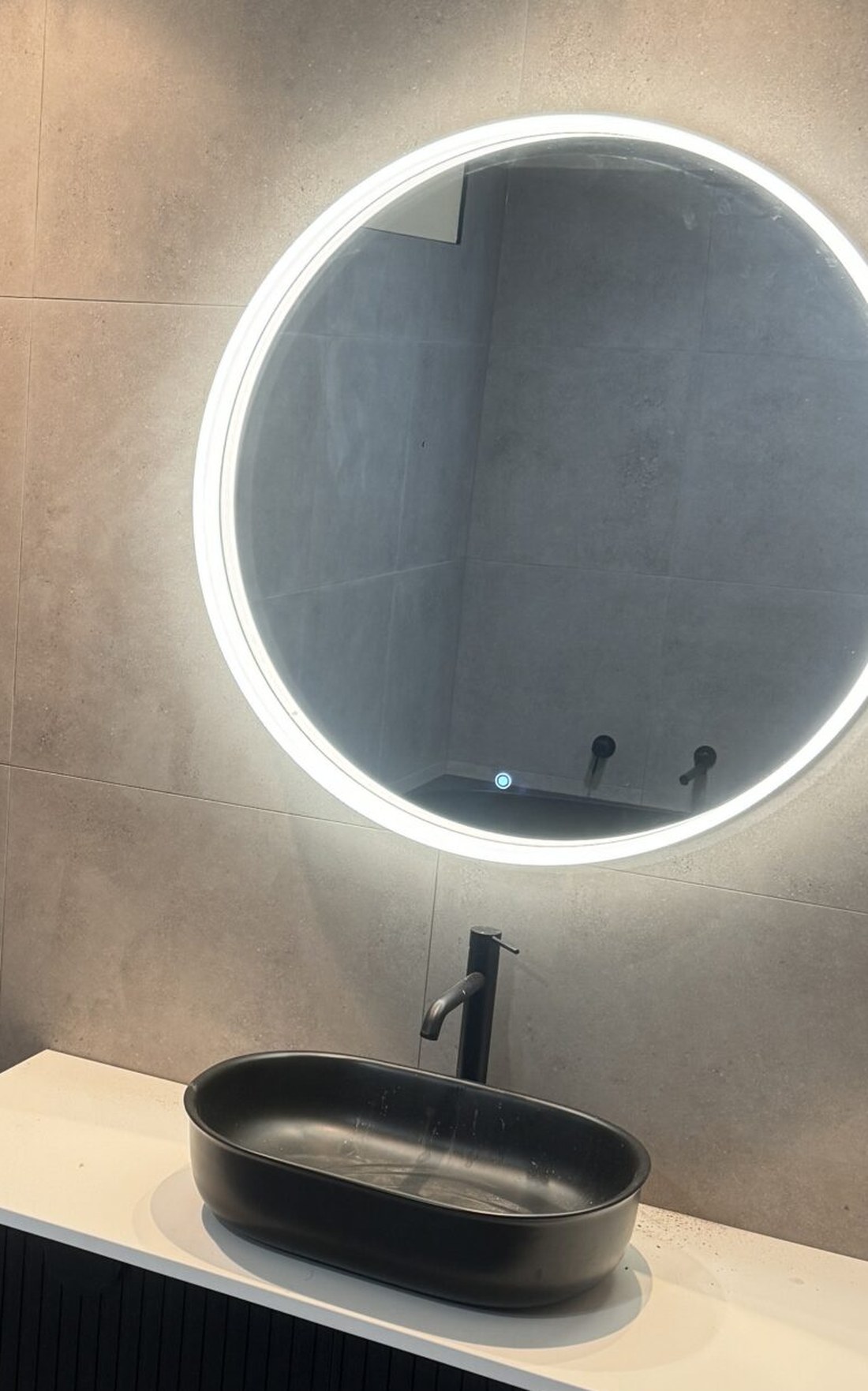 A2Z bathroom with a round backlit mirror, matte black basin and black ribbed wall-hung vanity